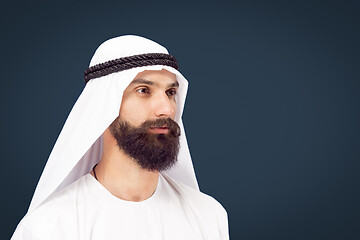 Image showing Arabian saudi businessman on dark blue studio background