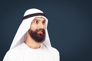 Image showing Arabian saudi businessman on dark blue studio background