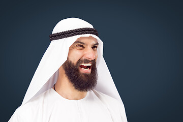 Image showing Arabian saudi businessman on dark blue studio background