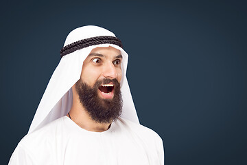 Image showing Arabian saudi businessman on dark blue studio background