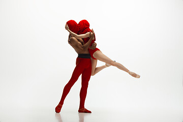 Image showing Young graceful couple of ballet dancers dancing on white studio background