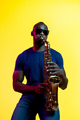 Image showing Young african-american jazz musician playing the saxophone