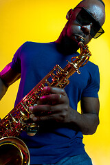 Image showing Young african-american jazz musician playing the saxophone