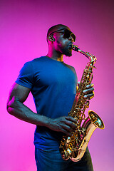 Image showing Young african-american jazz musician playing the saxophone