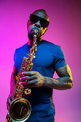 Image showing Young african-american jazz musician playing the saxophone