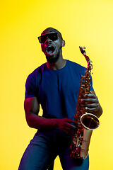 Image showing Young african-american jazz musician playing the saxophone