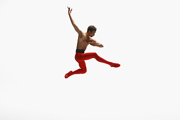 Image showing Young graceful male ballet dancer dancing on white studio background