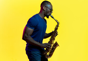 Image showing Young african-american jazz musician playing the saxophone