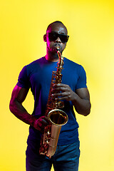 Image showing Young african-american jazz musician playing the saxophone