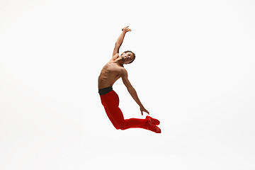 Image showing Young graceful male ballet dancer dancing on white studio background