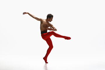 Image showing Young graceful male ballet dancer dancing on white studio background