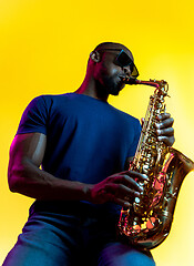 Image showing Young african-american jazz musician playing the saxophone