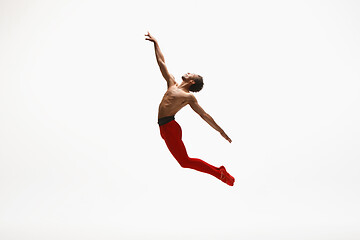 Image showing Young graceful male ballet dancer dancing on white studio background