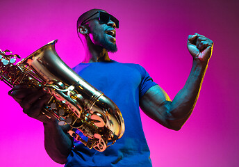 Image showing Young african-american jazz musician playing the saxophone