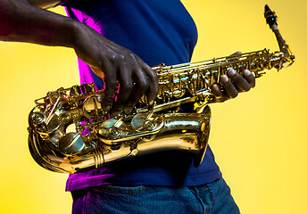 Image showing Young african-american jazz musician playing the saxophone