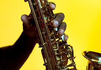 Image showing Young african-american jazz musician playing the saxophone