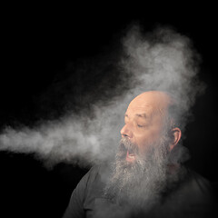 Image showing bearded man gets smoke in his face portrait