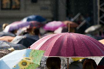 Image showing Crowd of people with umbrellas