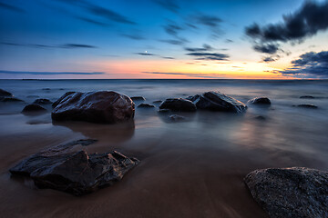 Image showing Sea sunset seascape with wet rocks
