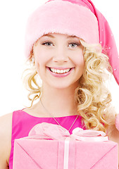 Image showing cheerful santa helper girl with gift box