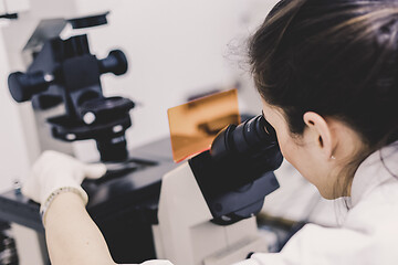 Image showing Life science researcher microscoping in genetic scientific laboratory.