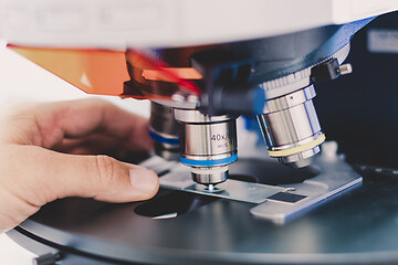 Image showing Scientist microscoping on fluorescent microscope.