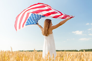 Image showing girl with american flag waving over cereal field