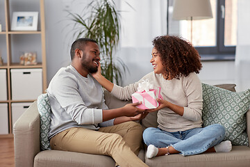 Image showing happy couple with gift at home