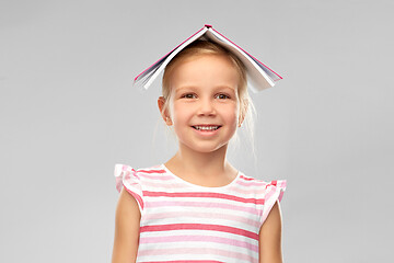 Image showing little girl with roof of book on top of her head