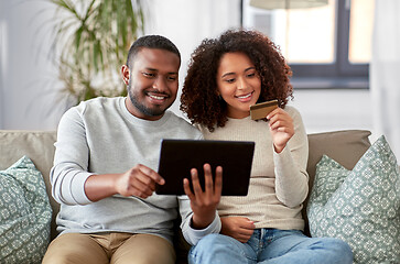 Image showing couple with tablet pc and credit card at home