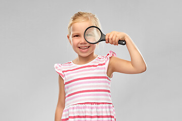 Image showing happy girl looking through magnifying glass