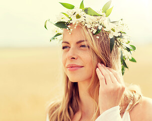 Image showing happy woman in wreath of flowers