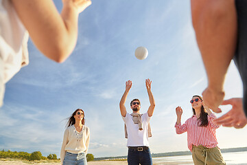 Image showing friends playing volleyball on beach in summer