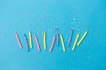 Image showing birthday candles with sprinkles on blue background