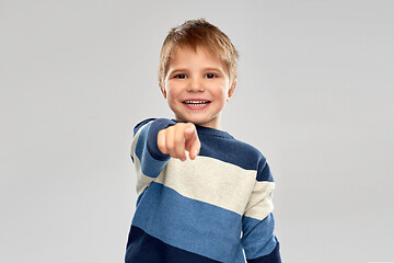 Image showing little boy in striped pullover pointing finger