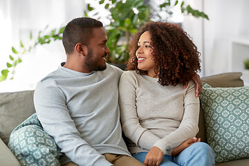 Image showing african american couple on sofa talking at home