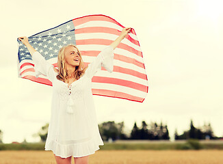 Image showing happy woman with american flag on cereal field