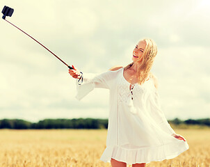 Image showing happy young woman taking selfie by smartphone