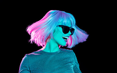 Image showing happy woman in pink wig and sunglasses dancing