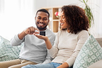 Image showing african american couple with smart speaker at home