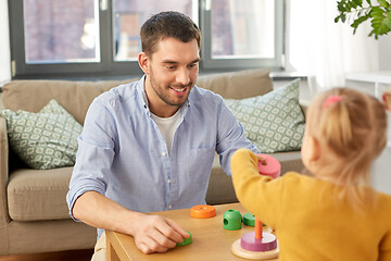 Image showing father playing with little baby daughter at home