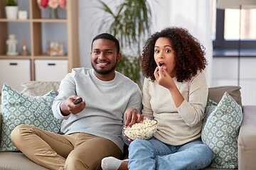 Image showing african couple with popcorn watching tv at home