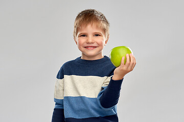 Image showing little boy in striped pullover with green apple