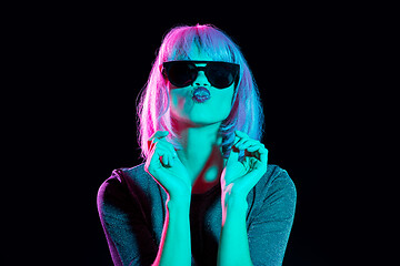 Image showing woman in wig and black sunglasses sending air kiss