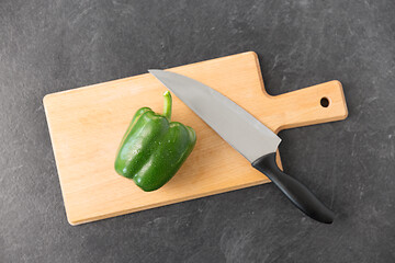 Image showing green pepper and kitchen knife on cutting board