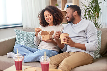 Image showing happy couple with takeaway food and drinks at home