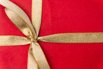 Image showing close up of christmas red gift box with golden bow