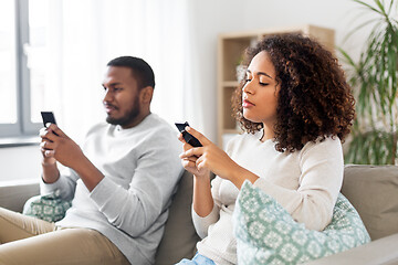 Image showing african american couple with smartphone at home