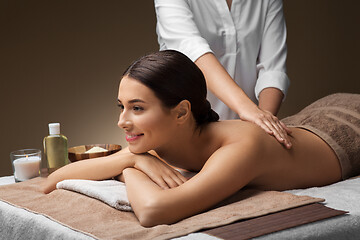 Image showing woman lying and having back massage at spa