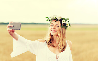 Image showing happy young woman taking selfie by smartphone